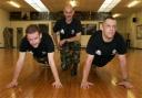 ARMY STYLE: Reporter Paul Duncan (left) with PTI Sgt Ian Aspin and Staff Sgt Pete Sharpe at the TA gymnasium in Barrow. Photo by Victoria Middleton