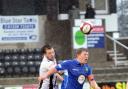Gavin Clark wins a header during the match against Kidsgrove Athletic