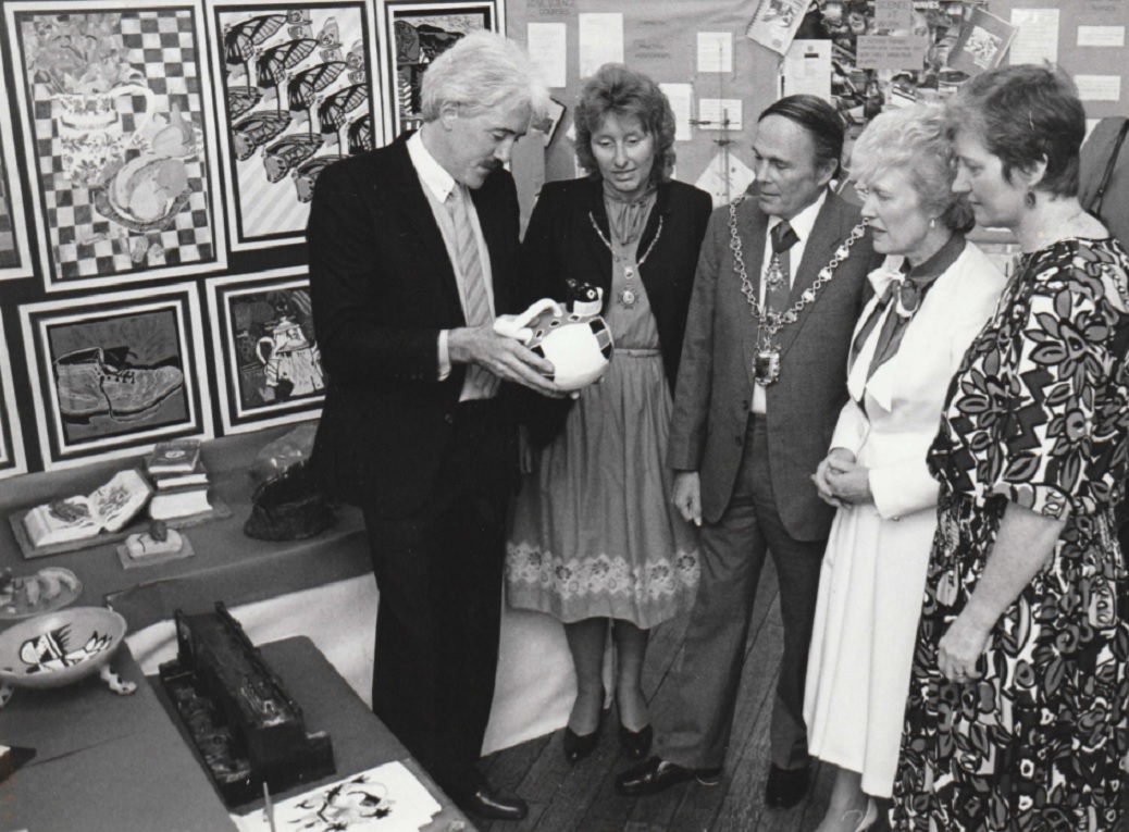 EXHIBIT: John Lewis, co-ordinator of a Queen Katherine School exhibition of work in Kendal Town Hall in 1987, discussing details of one of the fine ceramic items on display in the art department section. Visitors included the Mayor and Mayoress of