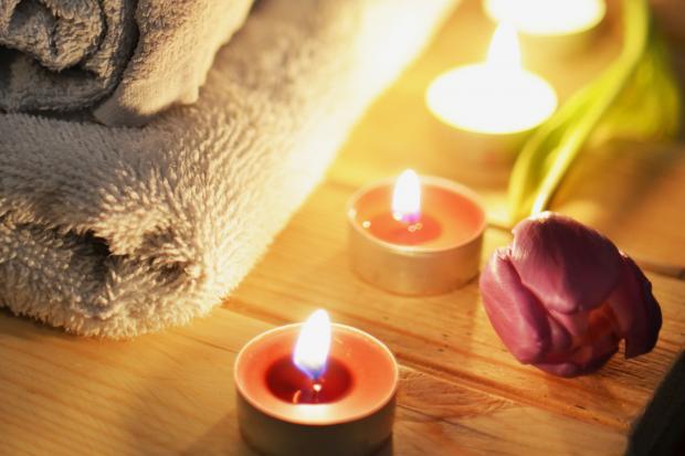 The Westmorland Gazette: A pile of towels, candles and a tulip. Credit: Canva