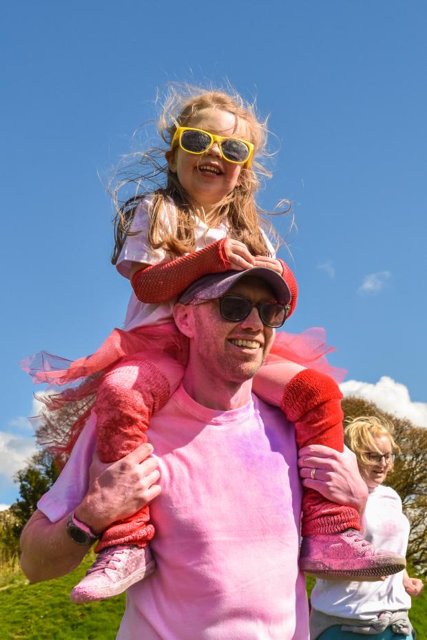 The Westmorland Gazette: SMILING: A young girl enjoying Kendal Colour Dash - Picture: Keith Douglas