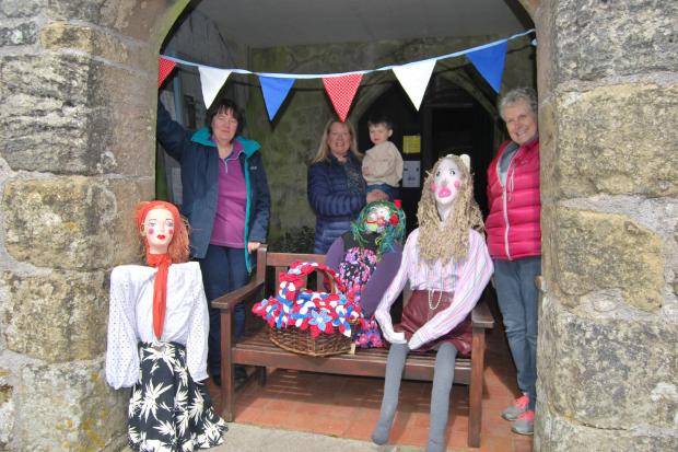 These villagers are making scarecrow guests for the Jubilee