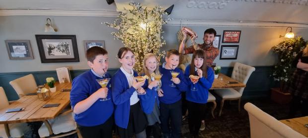 The Westmorland Gazette: Ye Olde Fleece Inn front of house manager Josh Farrant with the Selside School children and the mocktails they created