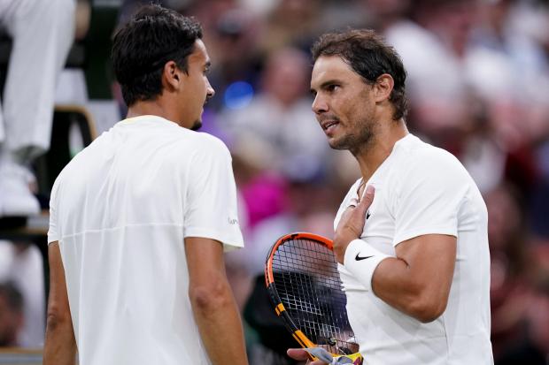 Rafael Nadal and Lorenzo Sonego speak at the net