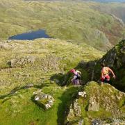 CHALLENGE: Runners descending Harrison Stickle, one of the peaks en route