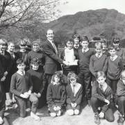 AWARD: Tony Johnstone, manager of the Nat West Bank at Ambleside, with John Ruskin School pupils who won a national award for their talking newspapers in 1989