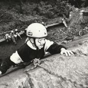 CLIMB: Claire Russell, ten, wears face paint as she tries out rock climbing at Lakeside YMCA in 1993