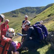 Mountain rescue teams combine to help walker after plunging down waterfall