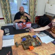 The members playing a game of Warhammer 40k