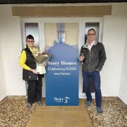 New homeowners Tina and Colin celebrate after being handed the keys to Story Homes' 10,000th home
