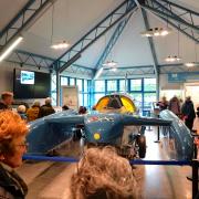 Bluebird K7 in Ruskin Museum, with the public looking at the new display