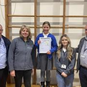Olivia and her award-winning poster with representatives from both Broadacres Housing Association and development partner Equans