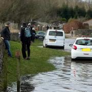 Cars and people cut off by the tide on Bank Holiday weekend