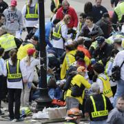 Medical workers help the injured near the Boston Marathon finish line