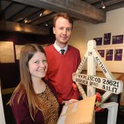 GRASMERE AT WAR DOVE COTTAGE EXHIBITION. Adam Lines and Jessie Petheram, Curatorial Assistants at Dove Cottage beside the temporary grave marker for Private Peascod, brought back from France and displayed as part of the exhibition. (12936403)