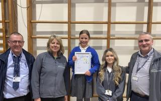 Olivia and her award-winning poster with representatives from both Broadacres Housing Association and development partner Equans